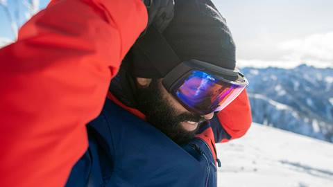 skier putting goggles on
