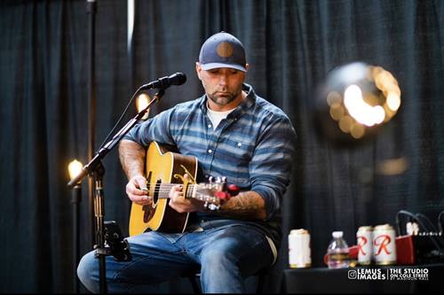 Aaron Saliba plays guitar