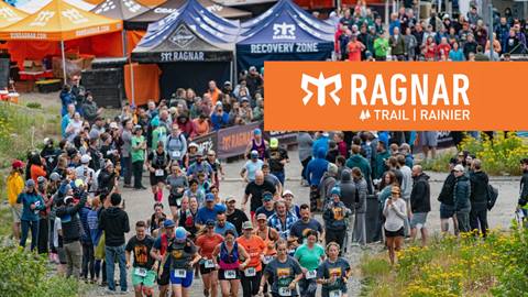 A crowd of racers cascade down a hill at the Ragnar Mt. Rainier Race