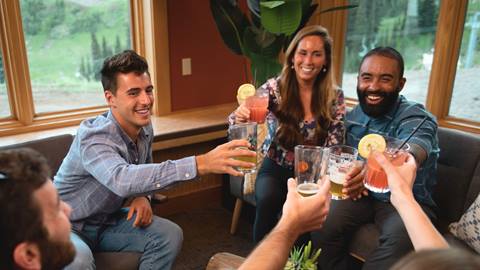 Group of co-workers cheers with smiles. 