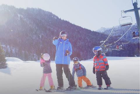 A ski instructor and her young students pose for a shot. 