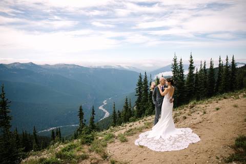 A couple poses above the river on Crystal Mountain