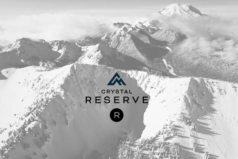 Image of snow-covered Crystal Mountain with a logo for Crystal Mountain Reserve in the foreground. 