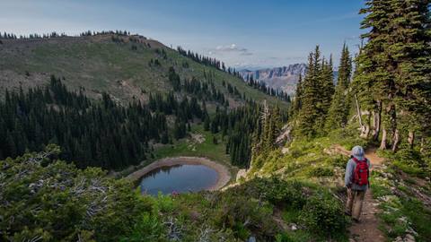 Hiker approaching alpine lake